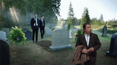 Man In Suit In Cemetery With Others GIF