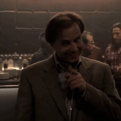 Man In Suit In Dark Room GIF