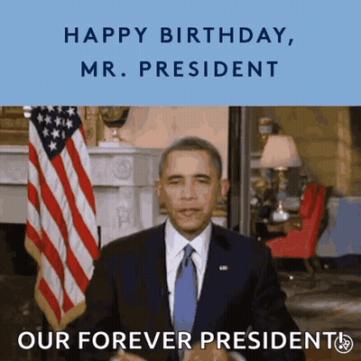 Man In Suit In Front Of American Flag Saying Happy Birthday Mr President GIF
