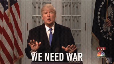 Man In Suit In Front Of American Flag Says We Need War GIF