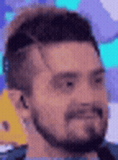 Man In Suit In Front Of Assistants Plateau Screen GIF