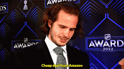 Man In Suit In Front Of Awards 2022 Wall GIF