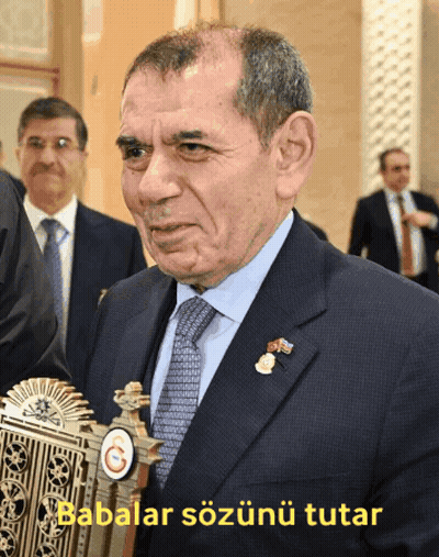 Man In Suit In Front Of Babalar Sign GIF