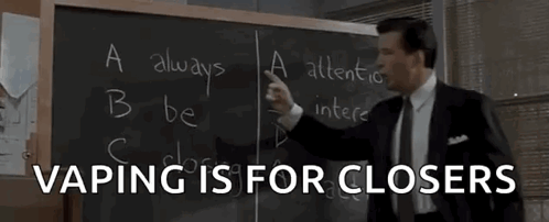 Man In Suit In Front Of Blackboard Saying Vaping Is For Closers GIF