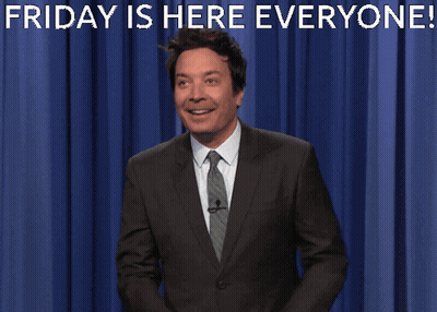 Man In Suit In Front Of Blue Curtain Saying Friday Is Here Everyone GIF