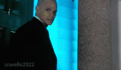Man In Suit In Front Of Blue Wall 2022 GIF