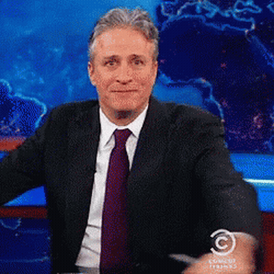 Man In Suit In Front Of Comedy Studios GIF