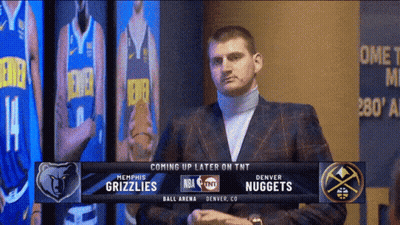 Man In Suit In Front Of Denver Nuggets Screen GIF