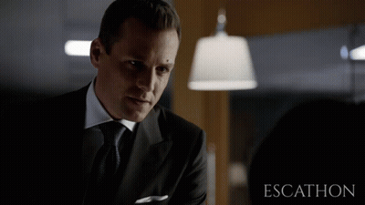 Man In Suit In Front Of Escalhon Sign GIF