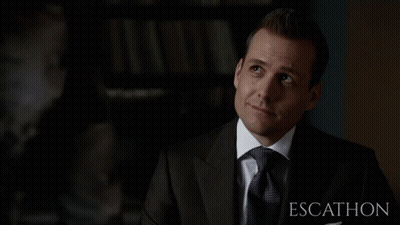 Man In Suit In Front Of Escalhon Sign GIF