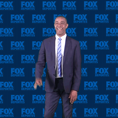Man In Suit In Front Of Fox Deportes Background GIF