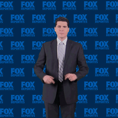Man In Suit In Front Of Fox Deportes Background GIF