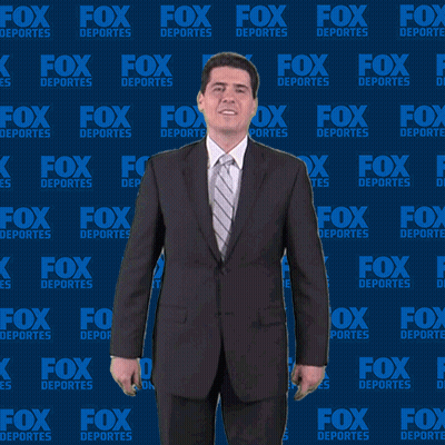 Man In Suit In Front Of Fox Deportes Wall GIF
