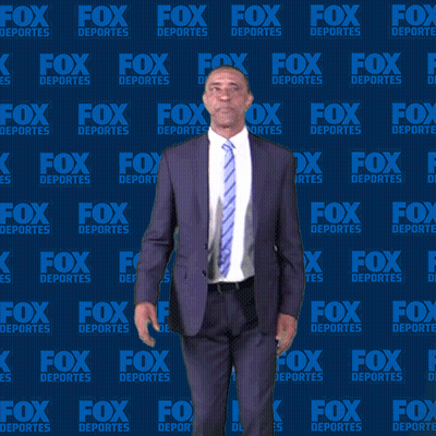 Man In Suit In Front Of Fox Deportes Wall GIF
