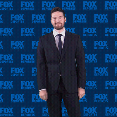 Man in Suit in Front of Fox Deportes Wall