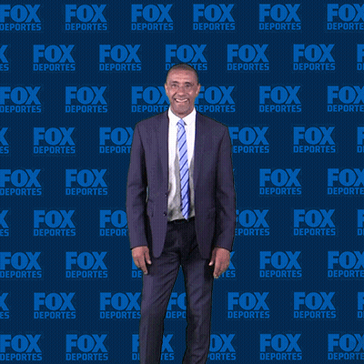 Man In Suit In Front Of Fox Deportes Wall GIF