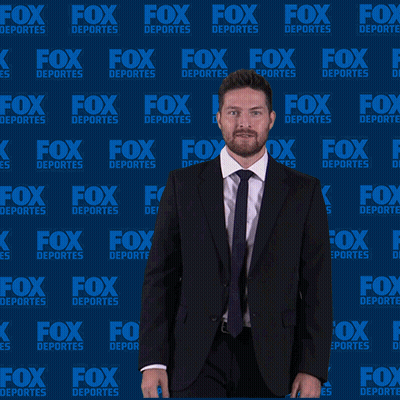 Man In Suit In Front Of Fox Deportes Wall GIF