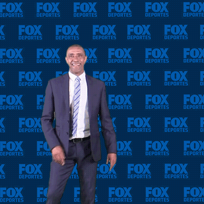 Man in Suit in Front of Fox Deportes Wall