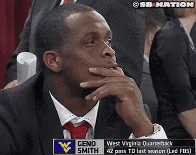 Man In Suit In Front Of Geno Smith Sign GIF