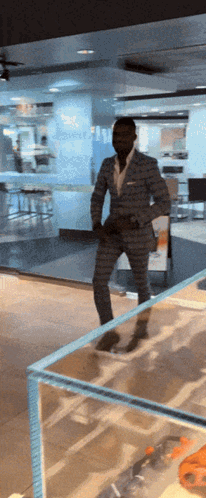 Man In Suit In Front Of Glass Wall GIF