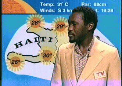 Man In Suit In Front Of Haiti Weather Map GIF