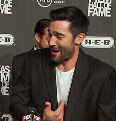 Man In Suit In Front Of Hall Of Fame Wall GIF