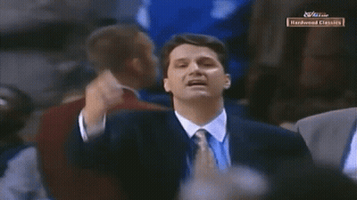 Man In Suit In Front Of Hardwood Classics Screen GIF