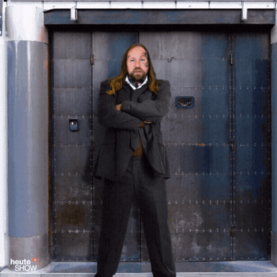 Man In Suit In Front Of Heute Show Door GIF
