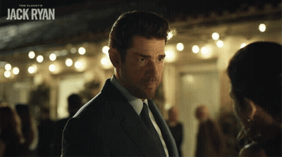 Man In Suit In Front Of Jack Ryan Sign GIF