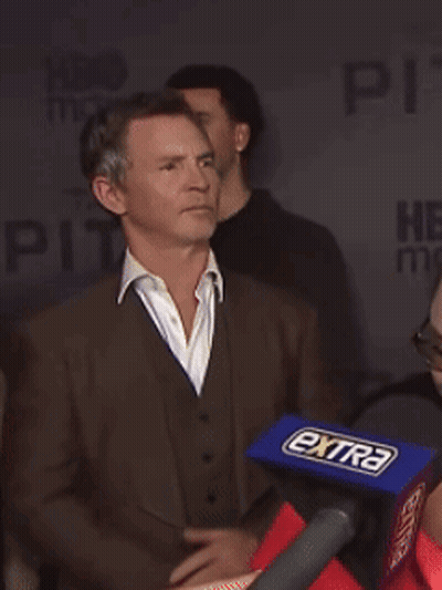 Man In Suit In Front Of Microphone Saying Extra GIF