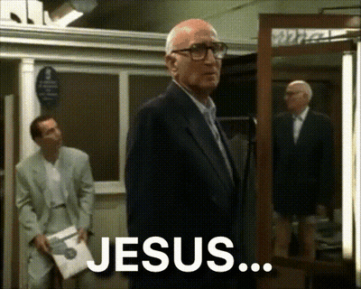 Man In Suit In Front Of Mirror Saying Jesus GIF