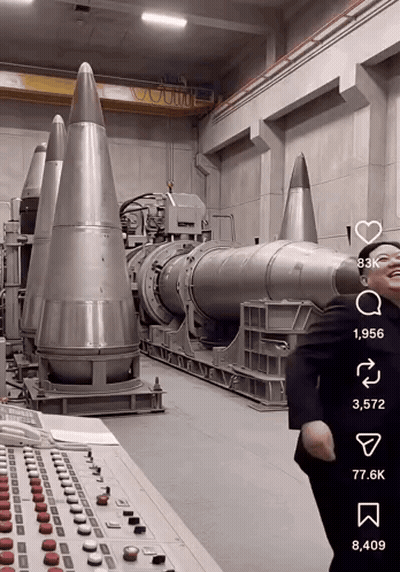 Man In Suit In Front Of Missiles GIF