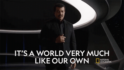 Man In Suit In Front Of National Geographic Sign GIF