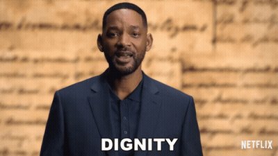 Man In Suit In Front Of Netflix Logo GIF
