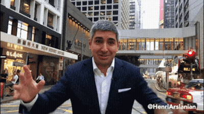 Man In Suit In Front Of New Penny House Building GIF