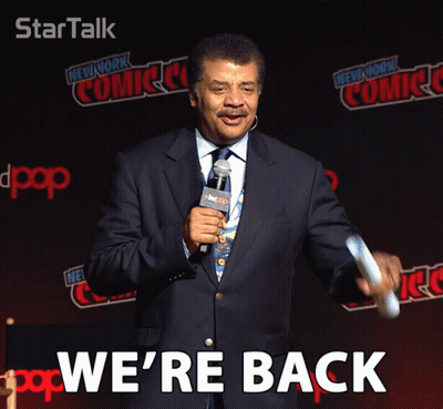 Man In Suit In Front Of New York Comic Con Wall GIF