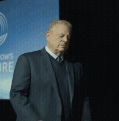 Man In Suit In Front Of OWS Sign GIF