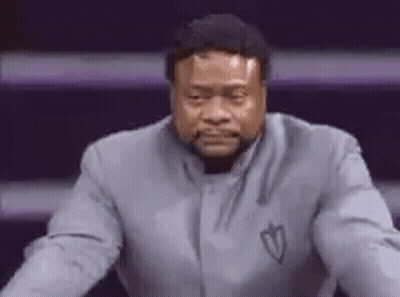 Man In Suit In Front Of Purple Wall GIF