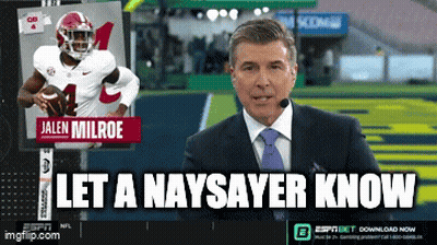 Man In Suit In Front Of Screen With Jalen Milroe GIF