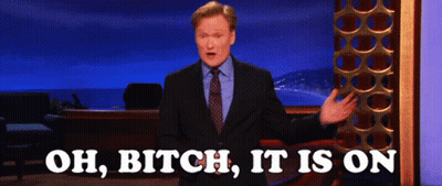 Man In Suit In Front Of Sign Saying Oh Bitch It Is On GIF