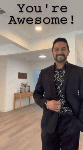 Man In Suit In Front Of Sign That Says You're Awesome GIF