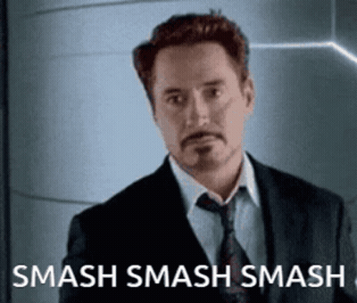 Man In Suit In Front Of Smash Smash Smash Sign GIF