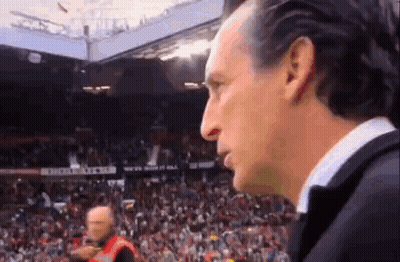Man In Suit In Front Of Soccer Crowd GIF