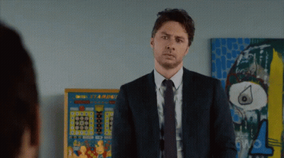 Man In Suit In Front Of Starburst Pinball Machine GIF