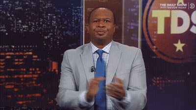 Man In Suit In Front Of TDS Sign GIF