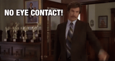 Man In Suit In Front Of Trophies Saying No Eye Contact GIF