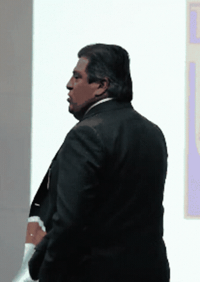 Man In Suit In Front Of Wall GIF