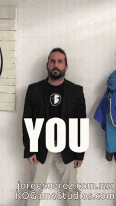 Man In Suit In Front Of Wall Saying You GIF