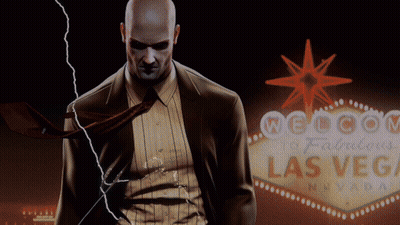 Man In Suit In Front Of Welcome To Las Vegas Sign GIF