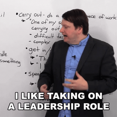 Man In Suit In Front Of Whiteboard Saying I Like Taking On A Leadership Role GIF